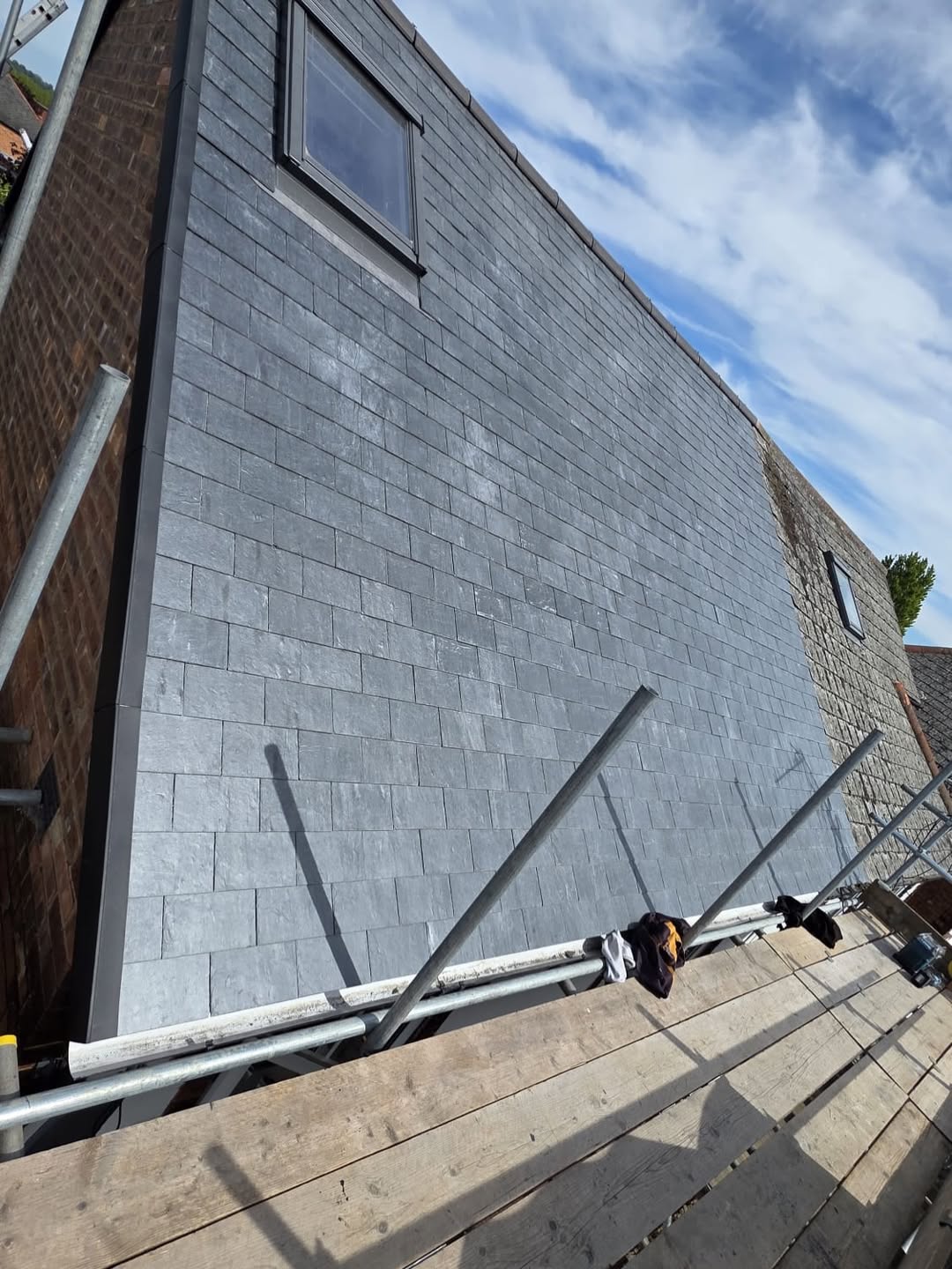 Vertical slate cladding with Velux window